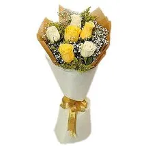 Imported yellow roses with statice and decorative leaves
